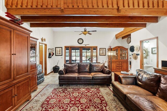 tiled living room featuring ceiling fan, french doors, beamed ceiling, and wood ceiling