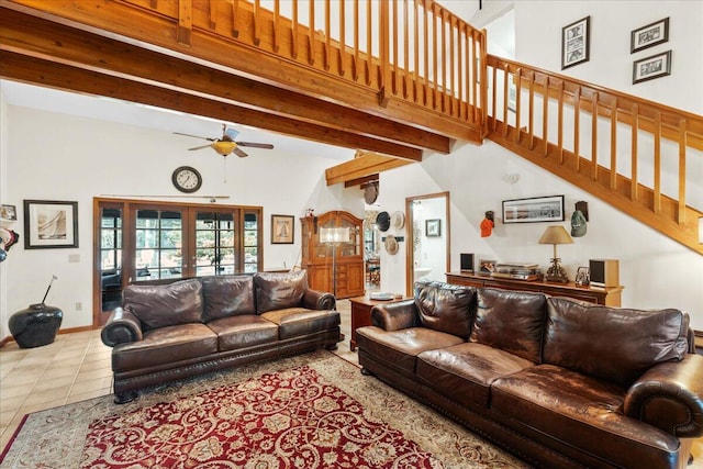 tiled living room featuring ceiling fan, beam ceiling, high vaulted ceiling, and french doors