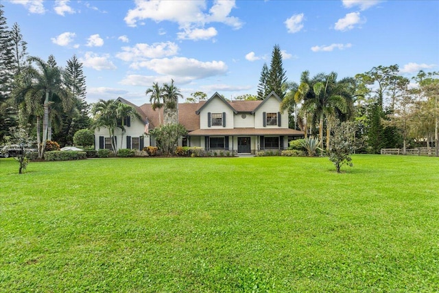 view of front of home with a front yard and a porch