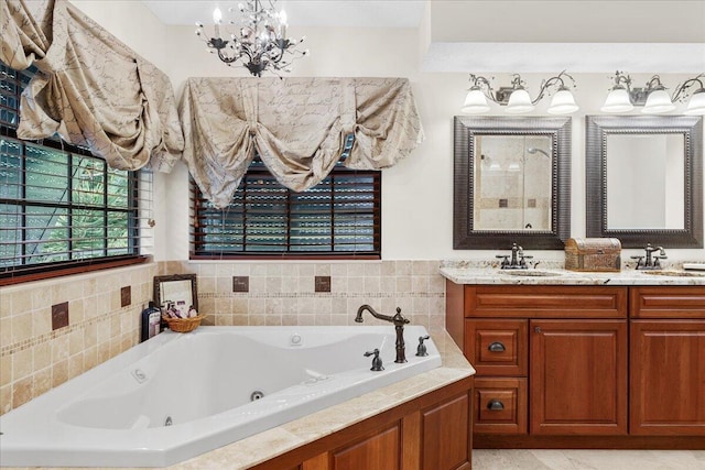 bathroom featuring a washtub, vanity, and a chandelier