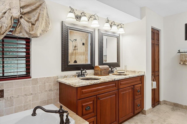 bathroom featuring vanity, tile patterned floors, and a tub