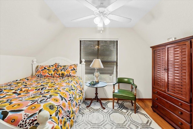 bedroom featuring ceiling fan, light hardwood / wood-style flooring, and vaulted ceiling