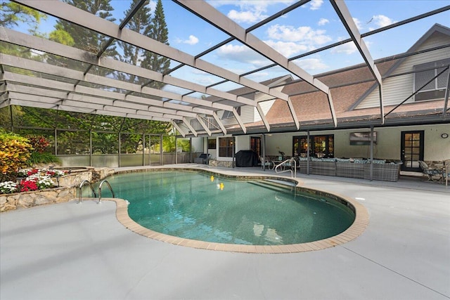 view of swimming pool with glass enclosure, an outdoor hangout area, and a patio