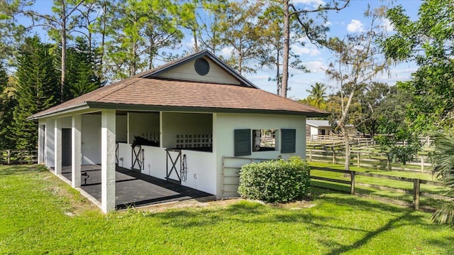 view of outbuilding featuring a lawn