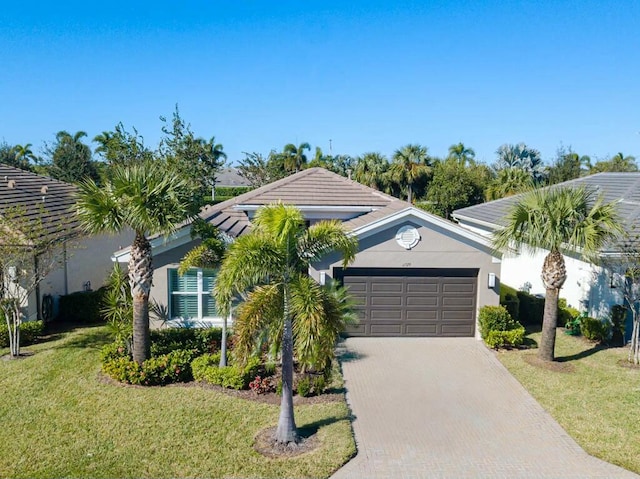 view of front of property with a front yard and a garage