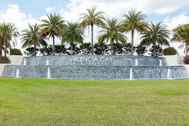 community sign featuring a yard