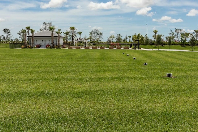 view of home's community with a gazebo and a yard