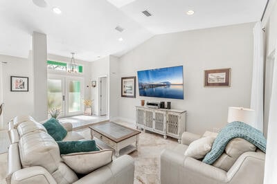 living room featuring french doors and vaulted ceiling