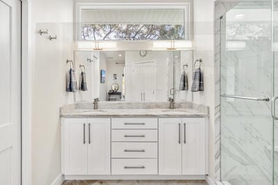 bathroom featuring vanity and a shower with shower door