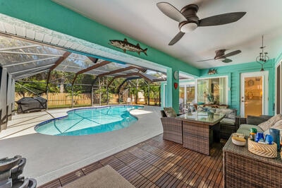 view of pool with a lanai, ceiling fan, a patio, and an outdoor hangout area