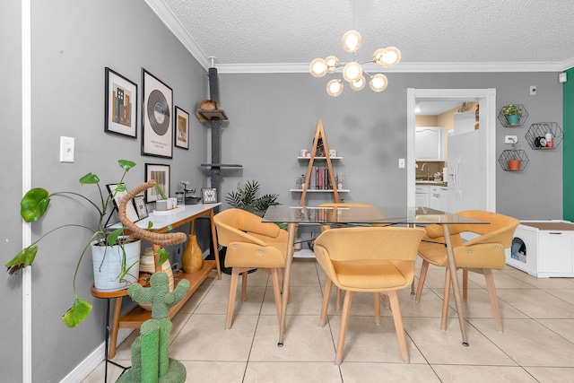 dining space with sink, an inviting chandelier, crown molding, a textured ceiling, and light tile patterned floors