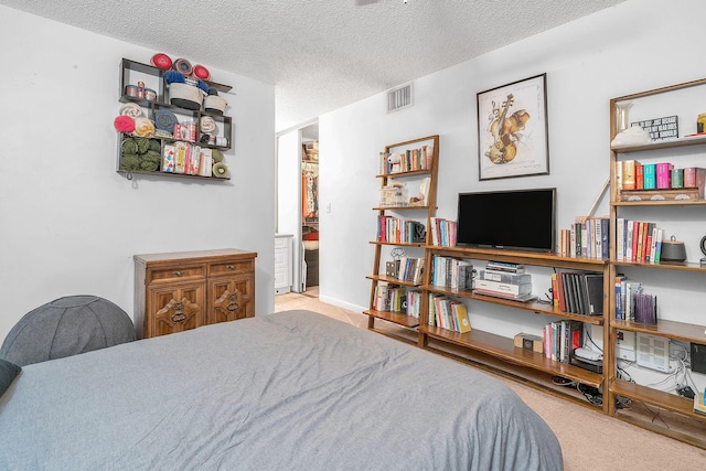 carpeted bedroom featuring a textured ceiling