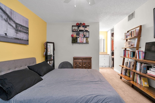 bedroom featuring carpet flooring, ceiling fan, and a textured ceiling