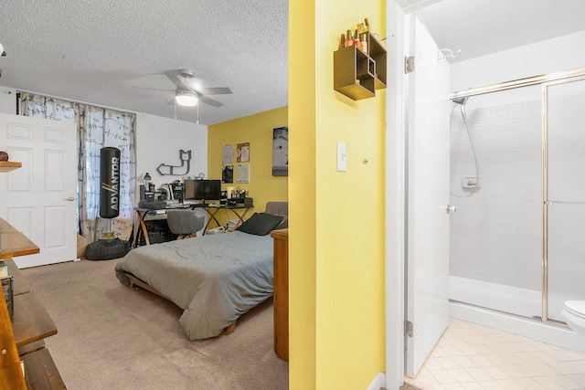 bedroom featuring ceiling fan, light colored carpet, and a textured ceiling