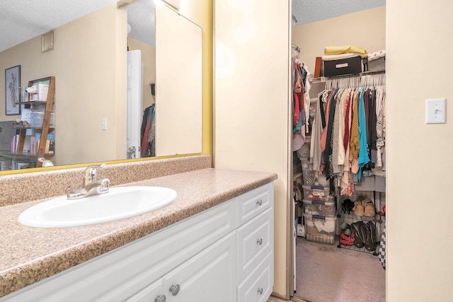 bathroom with vanity and a textured ceiling