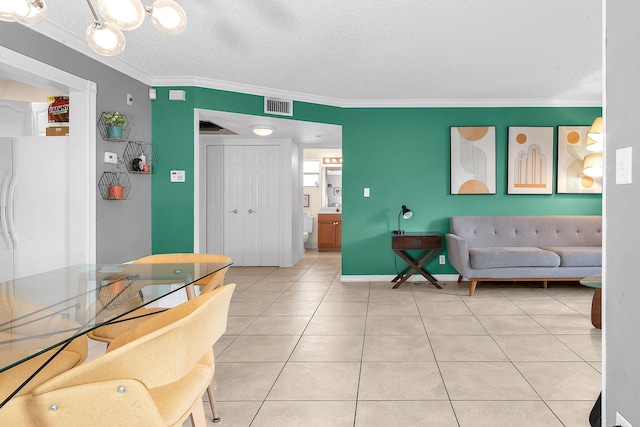 living room featuring a textured ceiling, crown molding, and tile patterned floors