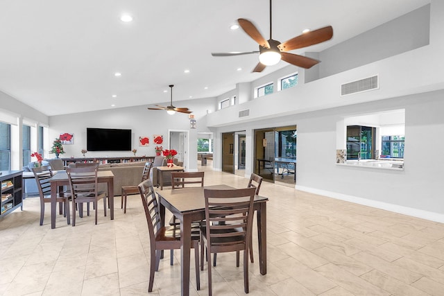 dining room with ceiling fan and high vaulted ceiling