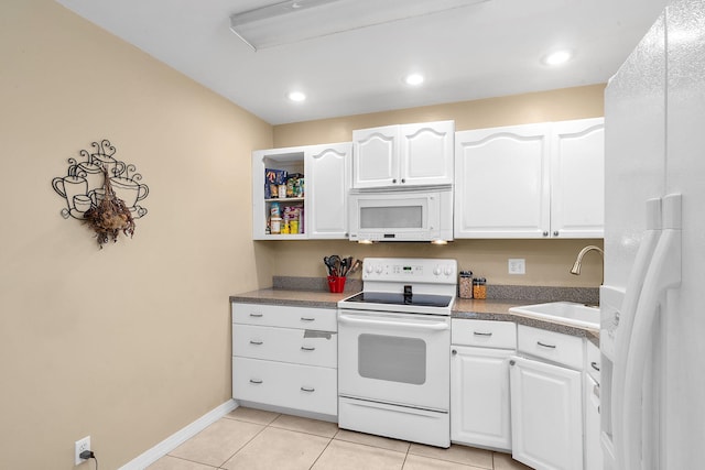 kitchen with white cabinets, white appliances, sink, and light tile patterned floors