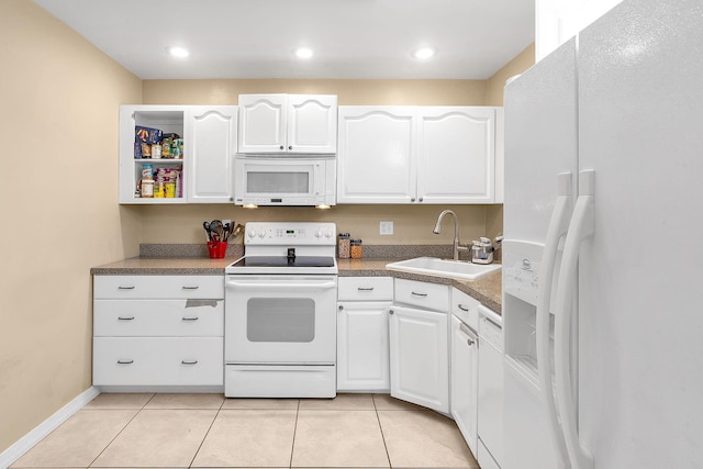 kitchen with white cabinetry, sink, and white appliances