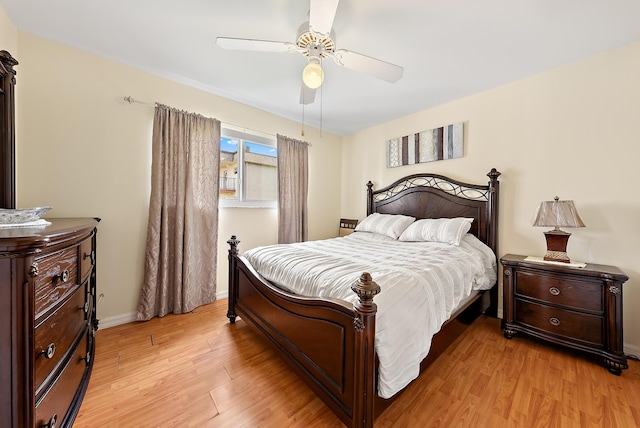 bedroom with light hardwood / wood-style floors and ceiling fan