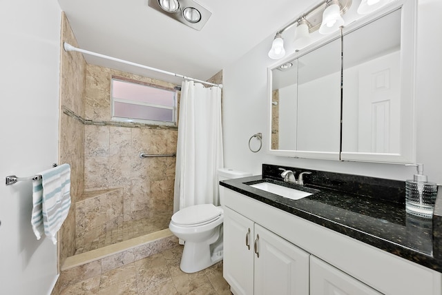 bathroom with vanity, toilet, and walk in shower