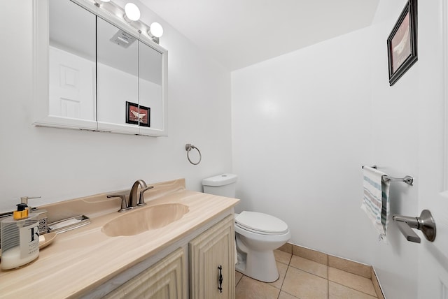 bathroom with tile patterned flooring, vanity, and toilet