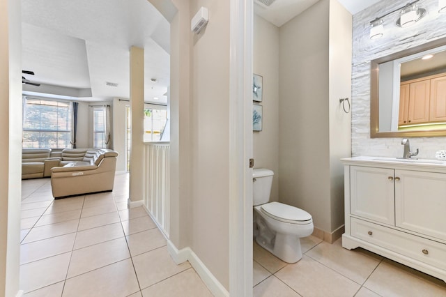 bathroom featuring tile patterned flooring, vanity, and toilet