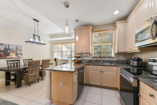 kitchen featuring sink, pendant lighting, light brown cabinets, and appliances with stainless steel finishes