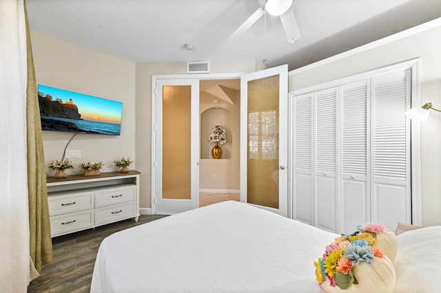 bedroom with ceiling fan, a closet, and dark wood-type flooring