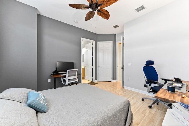 bedroom with ceiling fan, connected bathroom, and light hardwood / wood-style flooring