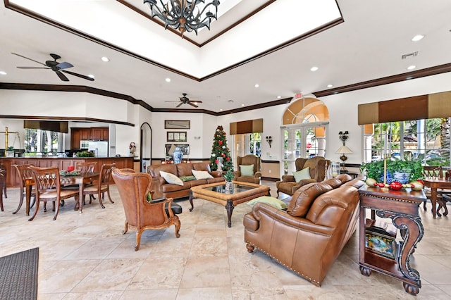 living room featuring ceiling fan with notable chandelier and crown molding