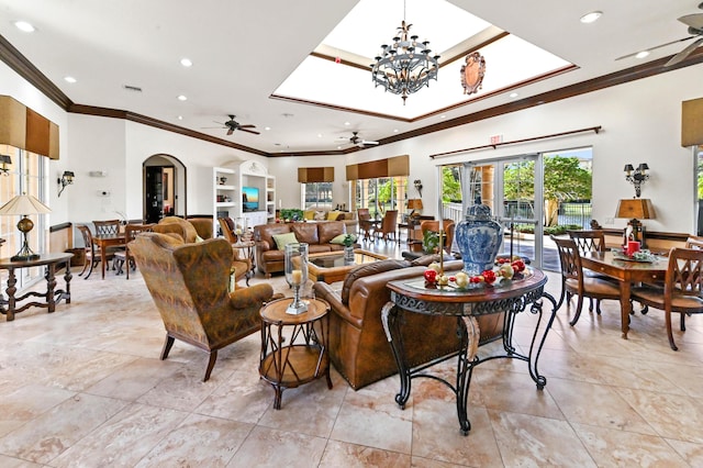 living room featuring ceiling fan with notable chandelier and ornamental molding