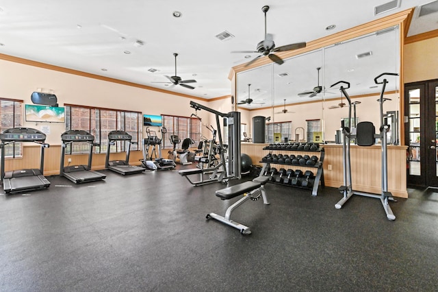 workout area featuring ceiling fan and ornamental molding