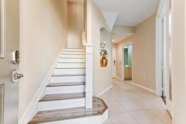 stairs featuring tile patterned flooring