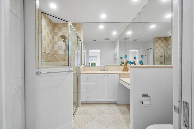 bathroom with tile patterned flooring, vanity, and an enclosed shower