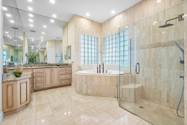 bathroom featuring tile patterned flooring, vanity, and independent shower and bath