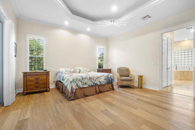 bedroom with multiple windows, ceiling fan, ensuite bathroom, and light hardwood / wood-style floors