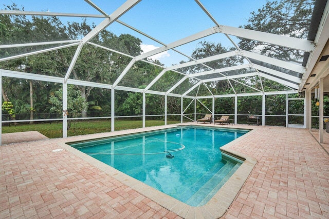 view of pool featuring a lanai, a patio area, and a yard