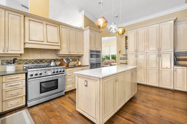 kitchen with dark wood-type flooring, stainless steel appliances, dark stone countertops, pendant lighting, and a kitchen island