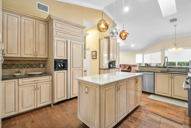 kitchen featuring a center island, hanging light fixtures, paneled built in refrigerator, and stainless steel dishwasher