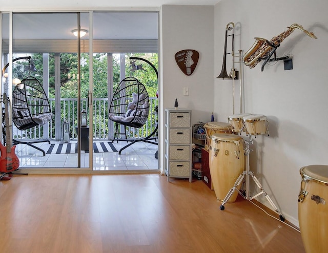 doorway with hardwood / wood-style floors and expansive windows