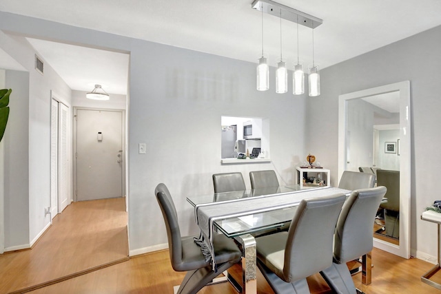 dining space featuring light hardwood / wood-style floors