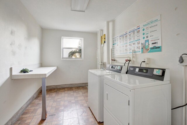 1000 NE 12th Ave Unit 304, Hallandale Beach, FL 33009 - shared laundry room featuring separate washer and dryer, baseboards, and light flooring