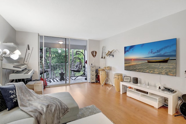 1000 NE 12th Ave Unit 304, Hallandale Beach, FL 33009 - living room featuring wood finished floors and floor to ceiling windows