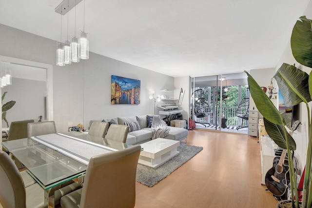 living room with hardwood / wood-style floors and an inviting chandelier