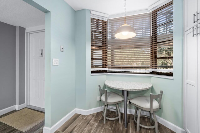 dining room featuring a wealth of natural light and hardwood / wood-style flooring