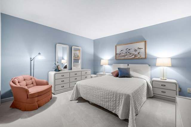 bedroom featuring light colored carpet