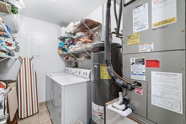 clothes washing area featuring electric water heater, washer and dryer, a textured ceiling, light tile patterned flooring, and heating unit