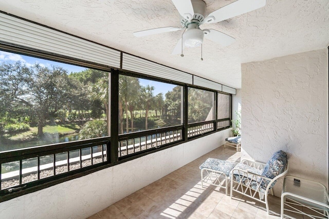 sunroom / solarium featuring ceiling fan