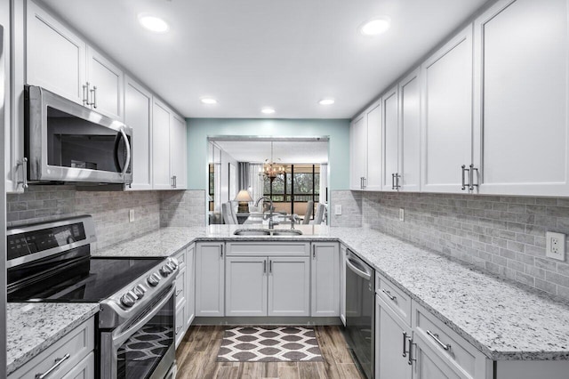 kitchen with white cabinetry, sink, appliances with stainless steel finishes, and dark wood-type flooring